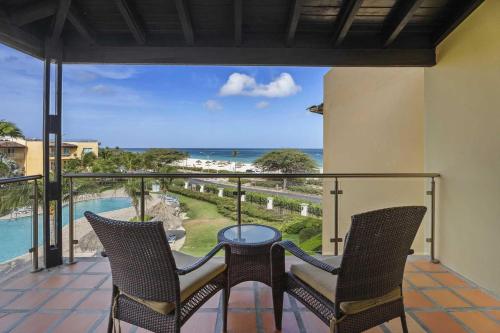 a balcony with a table and chairs and the ocean at Beachfront - Royal Penthouse 3BR condo - BC352 in Palm-Eagle Beach