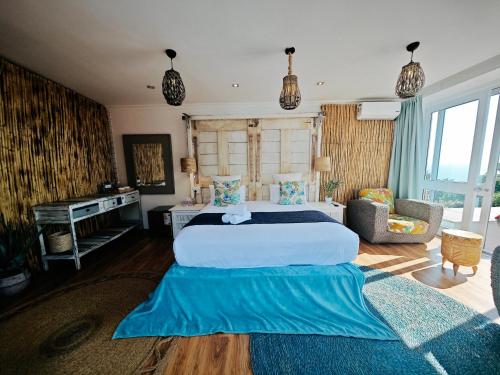 a large bedroom with a large bed and a desk at Beachwood Camps Bay in Cape Town