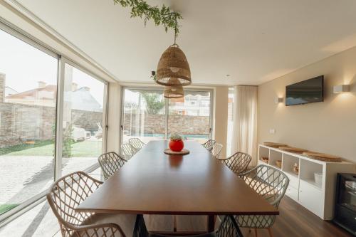 a dining room with a wooden table and chairs at Pool & Cinema Villa by Vacationy in Porto