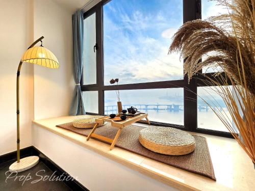 a window sill with a table and a table sidx sidx sidx at Cozy Seaview Suite Johor Bahru CIQ in Johor Bahru