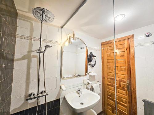 a bathroom with a sink and a mirror at Hotel Casa Morlans 3000 in Panticosa