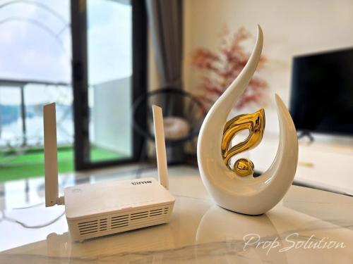 a white vase sitting on top of a table at Cozy Seaview Suite Johor Bahru CIQ in Johor Bahru