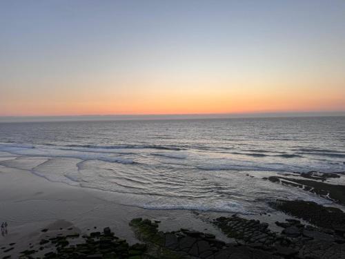 a view of the ocean at sunset at Atlantic Views Sintra Guest House in Colares