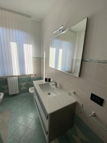 a bathroom with a sink and a mirror and a toilet at Dimora San Genesio in Casciana Terme