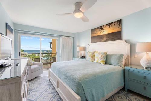 a bedroom with a bed and a view of the ocean at Beachfront - Emerald View 2BR condo - P416 in Palm-Eagle Beach