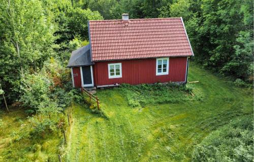 a red house with a red roof on a hill at Pet Friendly Home In Påryd in Påryd