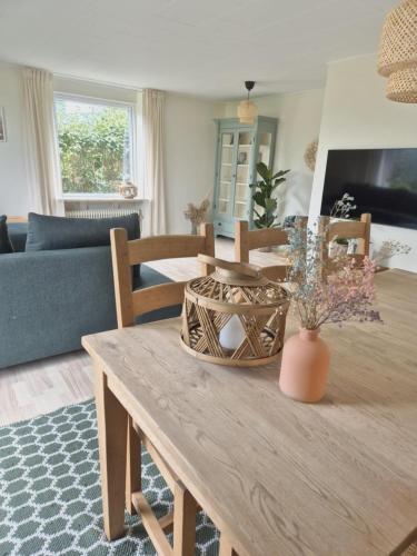 a living room with a wooden table and a couch at Apartment in Denmark - Hygge Villa in Otterup