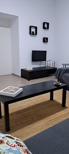 a living room with a bed and a coffee table at Casa do Arco Portalegre in Portalegre