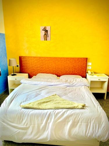a bedroom with a large bed with an orange headboard at Nile Valley Hotel in Luxor
