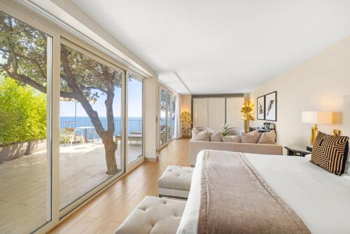 a bedroom with a bed and a view of the ocean at La Chèvre d'Or in Èze