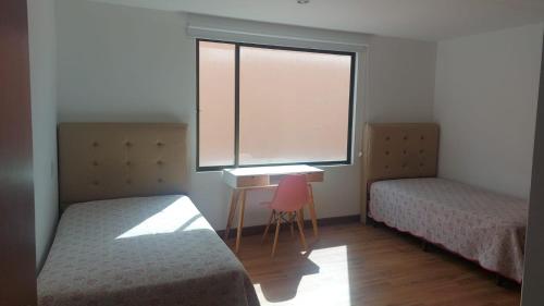 Llit o llits en una habitació de Espectacular Departamento
