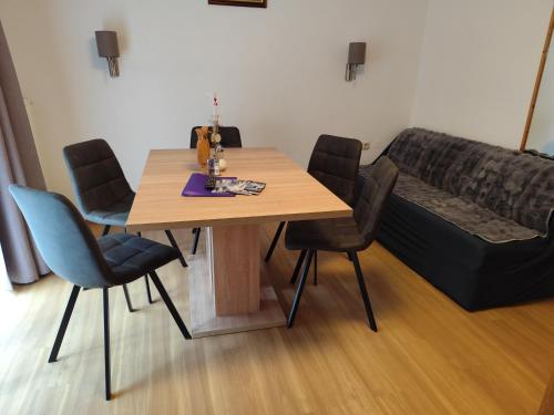 a table and chairs in a room with a couch at Apart Gschwandthof in Sankt Leonhard im Pitztal