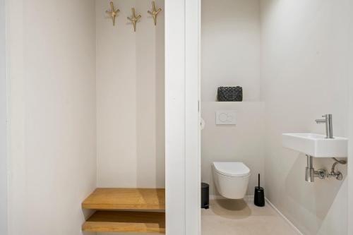 a bathroom with a toilet and a sink at Chez Victorine Kortrijk in Kortrijk