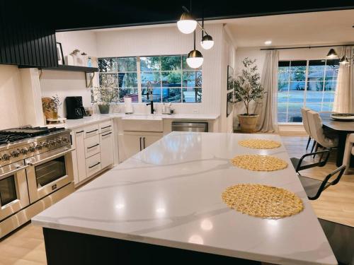 a kitchen with a large white island in a kitchen at Barrel Oak Mansion- Fire pit, & pool table NR TTU in Lubbock