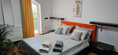 a bedroom with a bed with two towels on it at Apartments Sea Pearls in Supetar