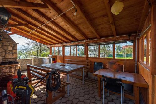 a cabin with a table and a bench in it at Villa Libero in Sarajevo