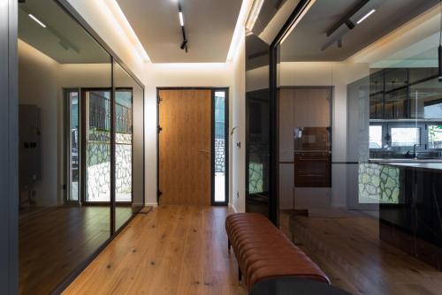 a living room with a couch and glass walls at Villa Libero in Sarajevo