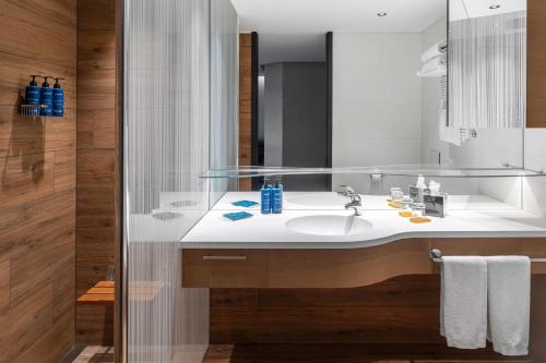 a bathroom with a sink and a shower at Radisson Blu Hotel, Bergamo ChorusLife in Bergamo