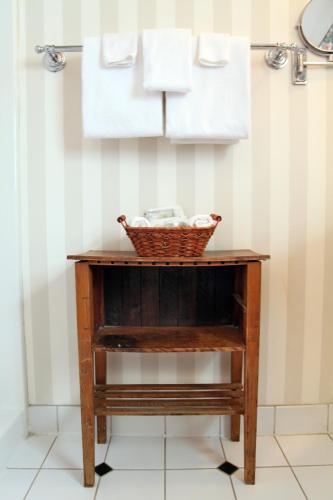 a basket on a table in a bathroom with towels at Albergo Allegria Hotel & Breakfast Restaurant in Windham