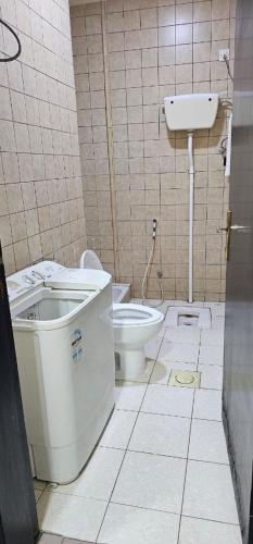 a bathroom with a toilet and a sink at شقق نواميس للشقق المخدومة in Khamis Mushayt