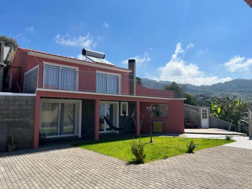 a red house with a hose on top of it at Mine House in Calheta
