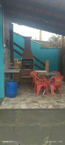 a group of red tables and chairs on a patio at Pousada Sonho na Ilha in Ilha Comprida