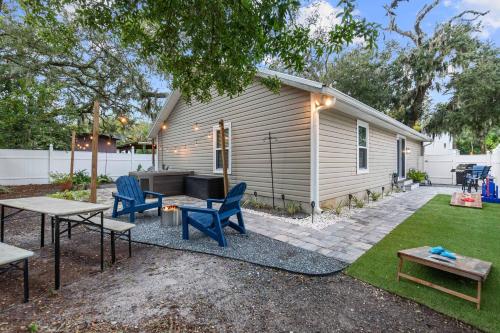 a backyard with chairs and a table and a house at Peaceful Pearl Retreat- 5 Minutes to Downtown, 10 Minutes to Beach in St. Augustine
