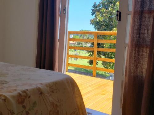 an open door to a balcony with a view of a deck at Refúgio Minimalista Tranquilidade a 600m da Praia in Governador Celso Ramos