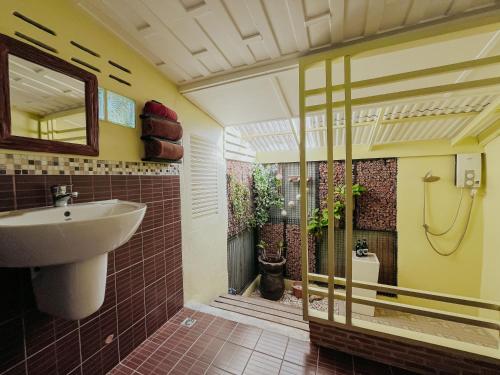 a bathroom with a sink and a toilet at Baan Bua Cottage SHA EXTRA PLUS B5510 in Ko Kood