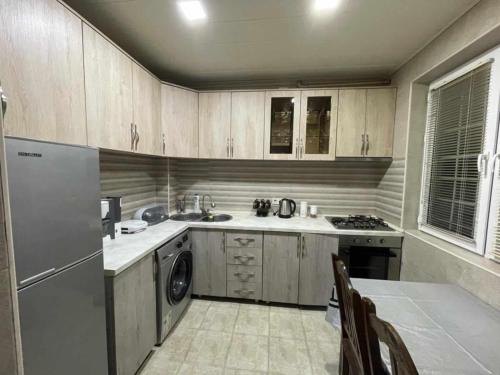 a kitchen with a sink and a dishwasher at Paata in Kutaisi