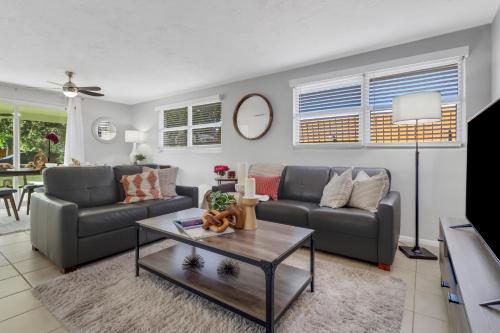 a living room with two couches and a table at Little Beach House w/ POOL&SPA - 5 minutes to Vanderbilt Beach (Pet Friendly) in Naples