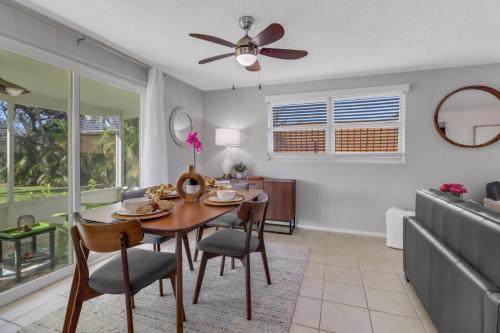 a dining room and living room with a table and chairs at Little Beach House w/ POOL&SPA - 5 minutes to Vanderbilt Beach (Pet Friendly) in Naples