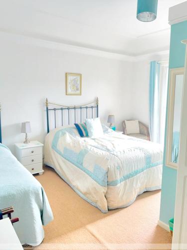 a bedroom with a bed and a chair in it at Portland House in Whitchurch