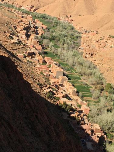 an aerial view of a village on the side of a mountain at Hôtel panoramique de la vallée in Aït Idaïr