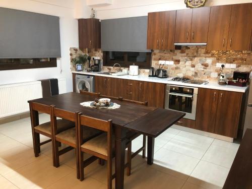 a kitchen with a wooden table and a stove at DIAMOND Stone Wooden Guest House in Khandria
