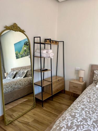 a bedroom with a mirror next to a bed at Villa Giulietta lake view Jacuzzi Spa 108 in Blevio