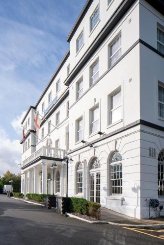 a white building sitting on the side of a street at London Croydon Aerodrome Hotel, BW Signature Collection in Croydon