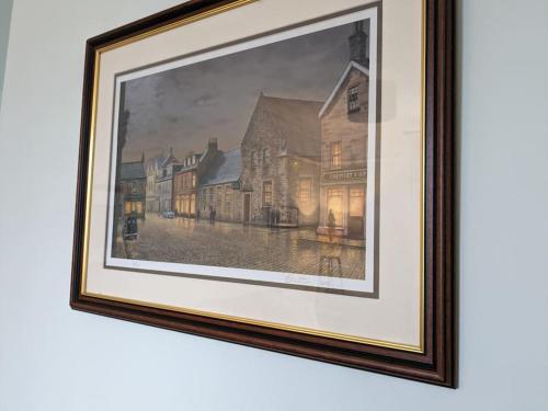 a painting of a street with buildings at Luxurious Georgian Town House in Langholm