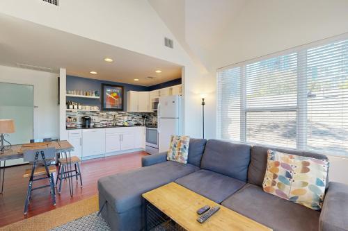 a living room with a couch and a table and a kitchen at Willow House Unit B in Austin