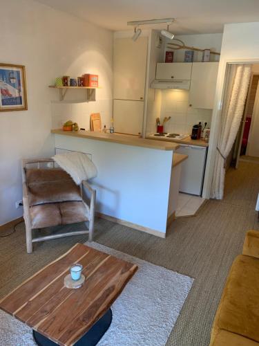 un salon avec une table et une cuisine dans l'établissement Isola 2000 appartement dans Chalet 4 ou 6 personnes grande terrasse, à Isola 2000