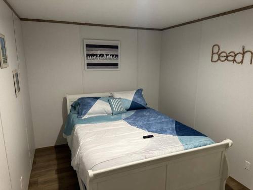 a small bedroom with a bed in the corner at Ferry Retreat in Cedar Island