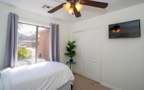 a bedroom with a bed and a ceiling fan at Modern home with big yard in Phoenix
