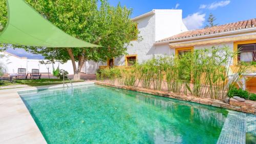 a swimming pool in front of a house at Casa Cerralba Pizarra by Ruralidays in Pizarra
