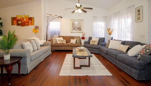 a living room with two couches and a table at Modern home with big yard in Phoenix