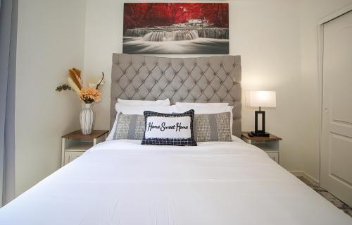 a bedroom with a large bed with a white bedspread at Modern home with big yard in Phoenix