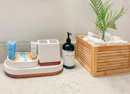a bathroom counter with two towels and a bottle of soap at Modern home with big yard in Phoenix