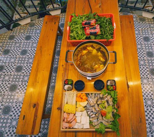 a wooden table with a bunch of food on it at Sol Inn - Moc Chau in Mộc Châu