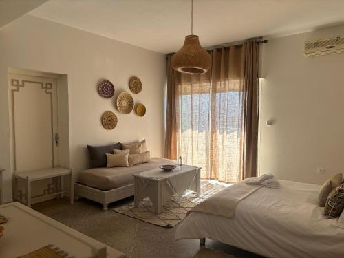 a living room with two beds and a table at Résidence Mer et soleil in Agadir