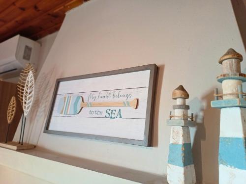 a picture of a lighthouse on a shelf with a sign at Nafplio Cottage-Grandma's Yard in Asini
