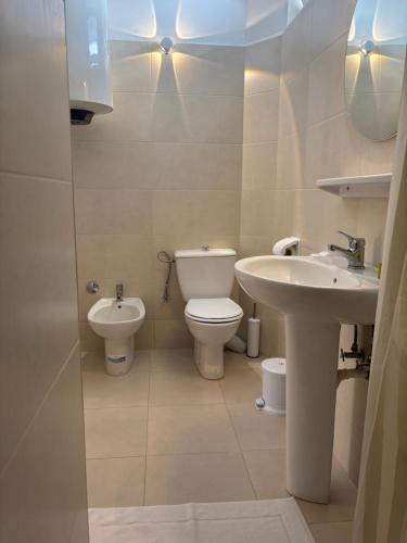 a bathroom with a toilet and a sink at Résidence Mer et soleil in Agadir